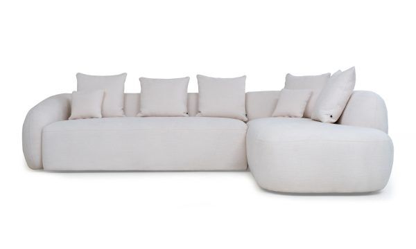 Sala en L Modular Demand de la marca Aristas, vista frontal. Presenta un diseño de líneas limpias y un acabado en tela suave de color Gante Marfil.