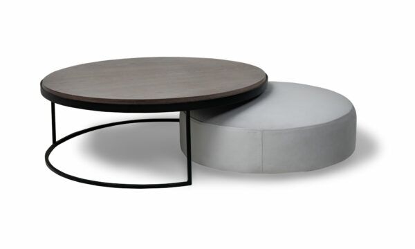 Juego de Mesa Centro Luna Mad 90 y Puff Luna 70 de la marca Aristas vista lateral. El conjunto presenta un diseño moderno y elegante, con formas redondeadas y acabados suaves. La mesa tiene una estructura robusta y minimalista, mientras que el puff complementa el conjunto con una estética igualmente sencilla y armónica.