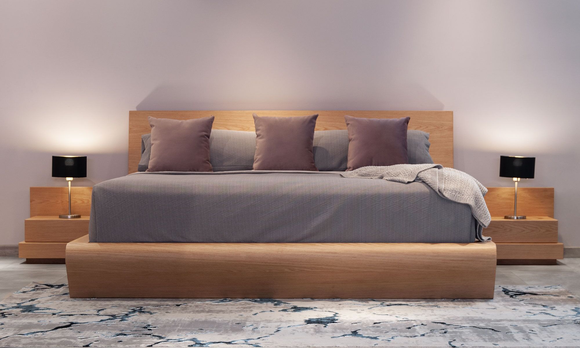 2.AMBIENTE-CAMA-ESE Vista frontal de la Cama Ese de Aristas. Un diseño minimalista que presenta una estructura de líneas limpias y un espaldar amplio en madera.